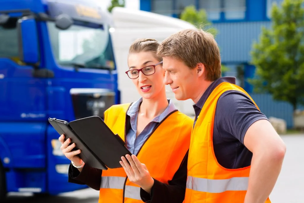 Forwarder in front of trucks on a depot